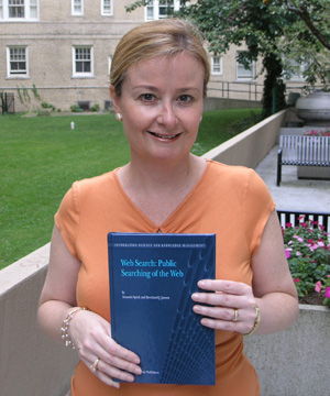 photo of Dr. Amanda Spink holding her new book